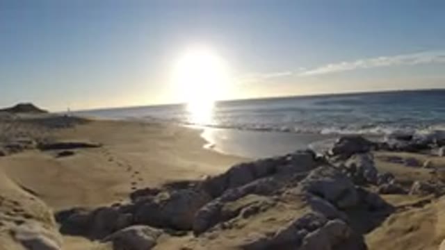 LOS CABOS MEXICO-2019: Peaceful Beach Moment with Waves and Footprints