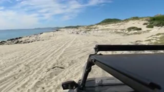 LOS CABOS MEXICO-2019: Wrangler Parked in Beach Area with Couple