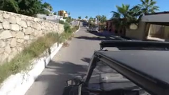 LOS CABOS MEXICO-2019: Camera Mounted To The Top Of A Jeep Going Down A Road In
