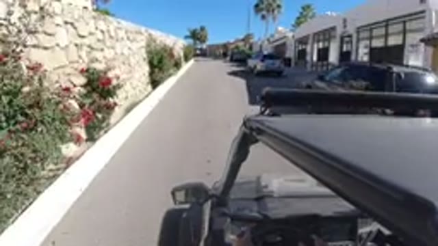 LOS CABOS MEXICO-2019: A Vehicle Traveling Through a Sunny Neighborhood
