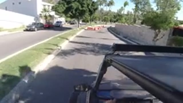 LOS CABOS MEXICO-2019: Vehicle Moves Along Divided City Street Past Orange Barricades