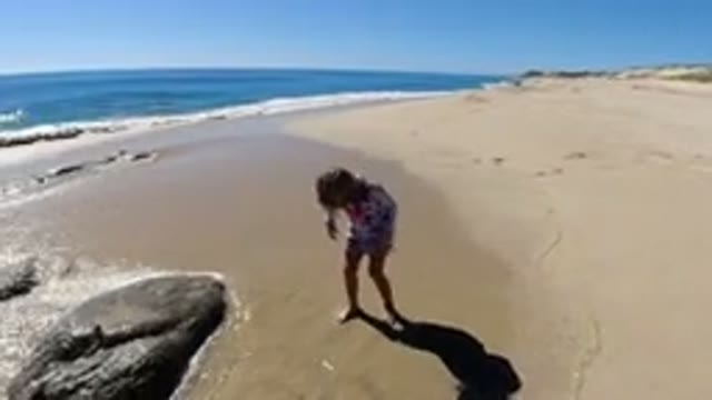 LOS CABOS MEXICO-2019: Young and Curious Child Standing on Sand by the Ocean