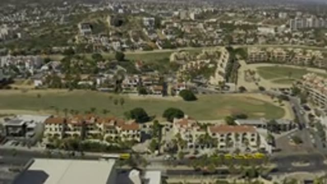 LOS CABOS MEXICO-2020: Top Side View Of A Beautiful Landscaped Town And Moving Vehicles