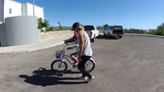 SAN JOSE DEL CABO MEXICO-2020: Mom Teaching Little Girl How To Ride A Bike