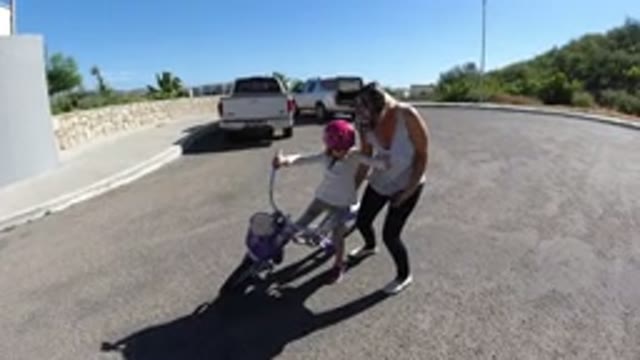 SAN JOSE DEL CABO MEXICO-2020: Mother Helping Her Daughter Ride A Bike For The First Time