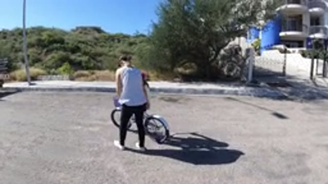 SAN JOSE DEL CABO MEXICO-2020: A Lady Teaching Her Daughter To Learn Cycling In