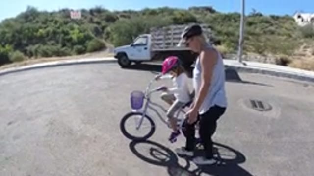 SAN JOSE DEL CABO MEXICO-2020: Mother Teaches Daughter How To Ride A Bike