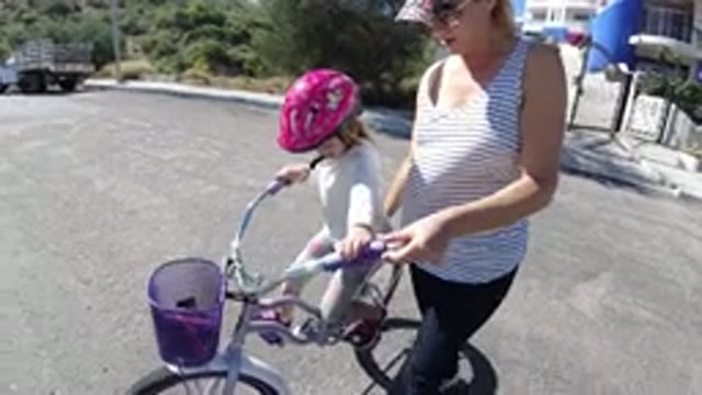 SAN JOSE DEL CABO MEXICO-2020: A Young Lady Teaches Cycling to Her Small Girl