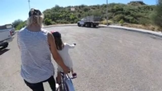 SAN JOSE DEL CABO MEXICO-2020: A Mother Helps Her Daughter Ride a Bicycle