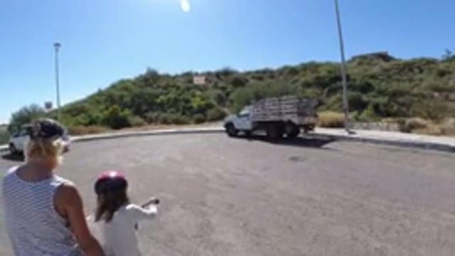 SAN JOSE DEL CABO MEXICO-2020: Mother Helping Daughter Ride Her Bicycle While