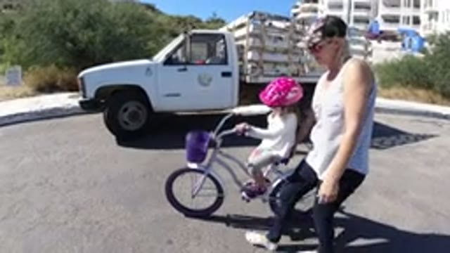 SAN JOSE DEL CABO MEXICO-2020: Mom Teaching Her Daughter How To Ride A Bike In