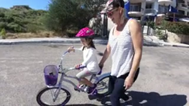 SAN JOSE DEL CABO MEXICO-2020: A Young Lady Supports and Teaches Her Daughter to Cycle