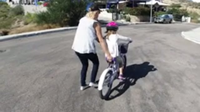 SAN JOSE DEL CABO MEXICO-2020: Mom Teaches Daughter to Ride Bicycle