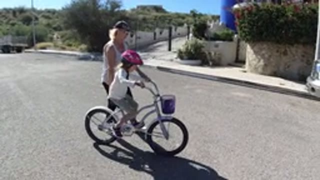 SAN JOSE DEL CABO MEXICO-2020: Mother Teaching Baby to Ride Bicycle