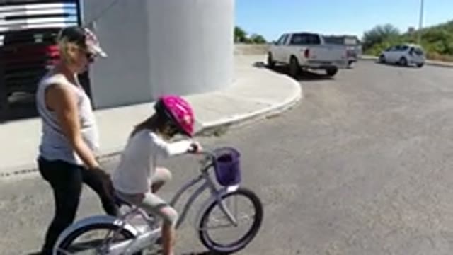 SAN JOSE DEL CABO MEXICO-2020: Mom Teaching The Little Girl On A Bicycle How To Ride