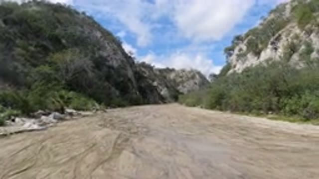 SAN JOSE DEL CABO MEXICO-2020: Someone Walking Through The Muddy Road In The Mountain Valley