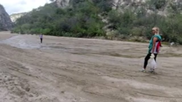 SAN JOSE DEL CABO MEXICO-2020: A Kid Jumping On Wet Sand Road And The Mother