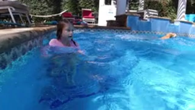 SAN JOSE DEL CABO MEXICO-2020: A Kid And A Dog Swimming In The Pool