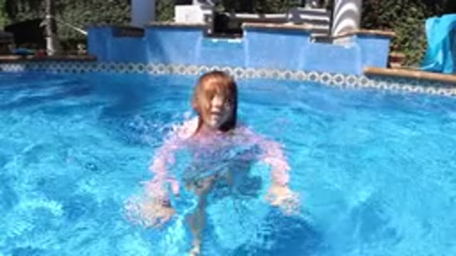 SAN JOSE DEL CABO MEXICO-2020: A Young Child Goes Under Water As A Large Dog