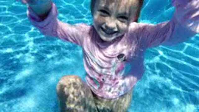 SAN JOSE DEL CABO MEXICO-2020: Little Girl Playing And Swimming Under The Clear Pool