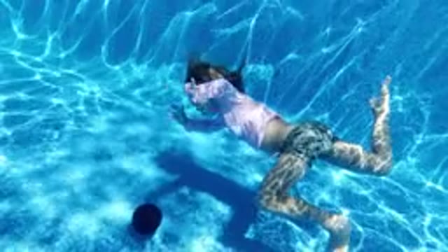 SAN JOSE DEL CABO MEXICO-2020: Kid Playing Diving In A Blue Pool In The Middle