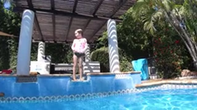 SAN JOSE DEL CABO MEXICO-2020: A Kid Is About To Get Into The Pool With A Dog In