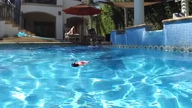 SAN JOSE DEL CABO MEXICO-2020: Child Girl Playing With Doll In House Pool With Parents