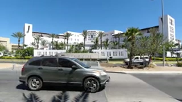 LOS CABOS MEXICO-2020: A View Of A Large Wide Building With Cars Driving In
