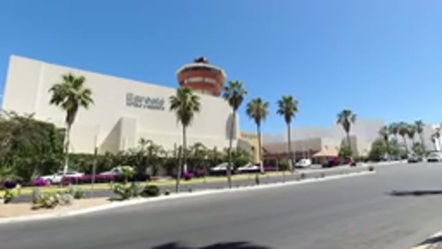 LOS CABOS MEXICO-2020: Cars Drive Past The Store Front Down The Road On A Sunny Day