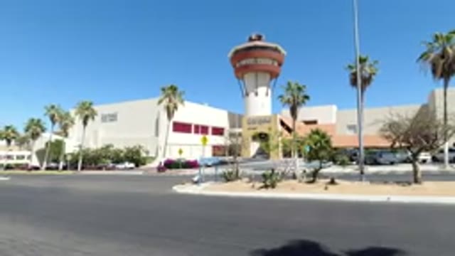 LOS CABOS MEXICO-2020: Large Shopping Plaza Mall Is White And Red Surrounding By Palm Trees And Buildings
