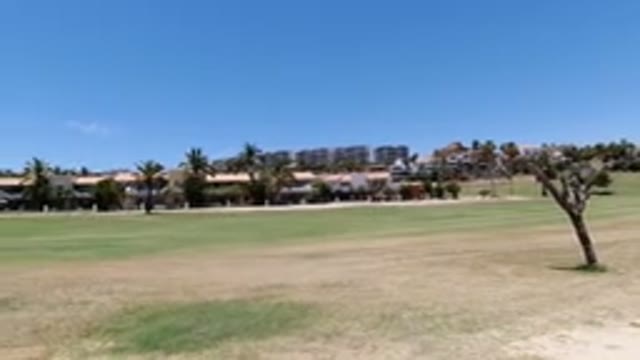 LOS CABOS MEXICO-2020: A View Of An Area With A Large Field Buildings And Trees