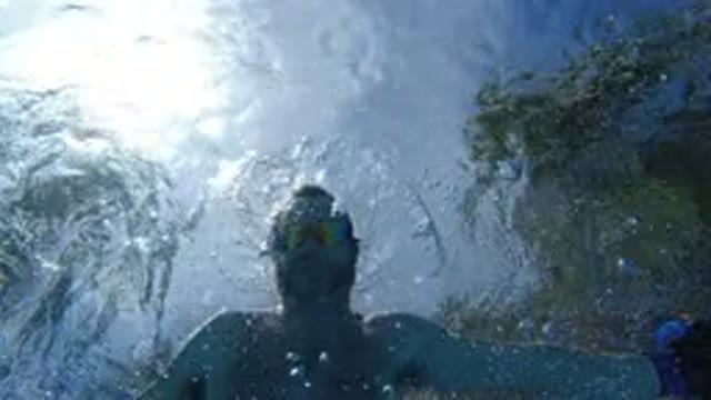 LOS CABOS MEXICO-2020: Man Swimming Underwater With Goggles And Swimming Trunks