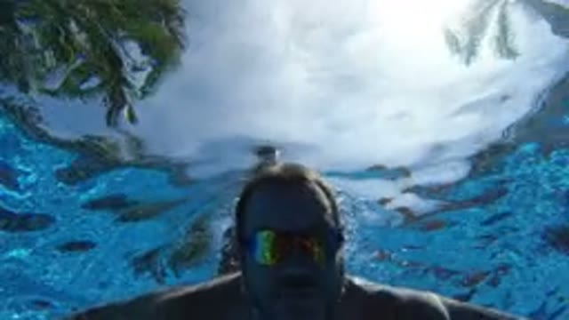 LOS CABOS MEXICO-2020: Underwater View Of A Swimming Man Wearing An Air Mat
