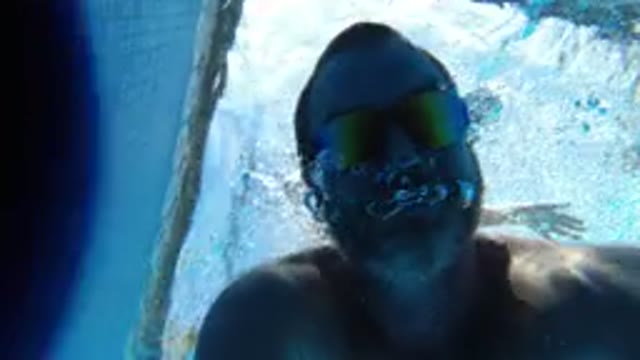 LOS CABOS MEXICO-2020: Man Diving In A Pool With Goggles Gets His Head Out And Shakes It