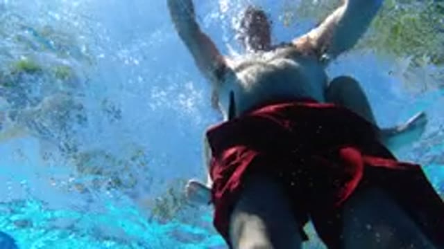 LOS CABOS MEXICO-2020: Man in Red Swim Trunks Paddling in Pool
