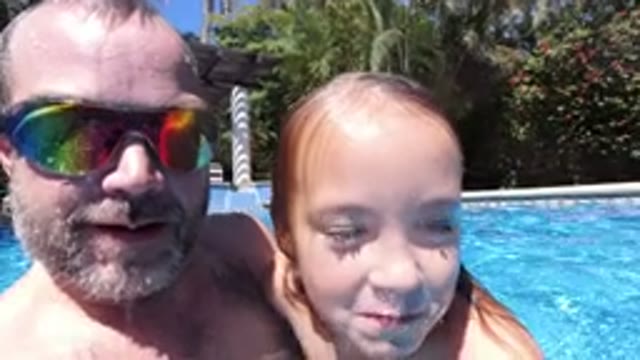 LOS CABOS MEXICO-2020: A Small Girl With Her Father In A Pool Saying Something