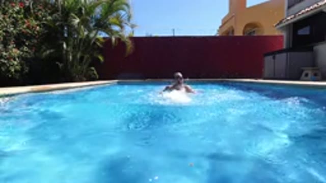 LOS CABOS MEXICO-2020: Man Swimming in Blue Water Pool on Clear Day in Back Yard