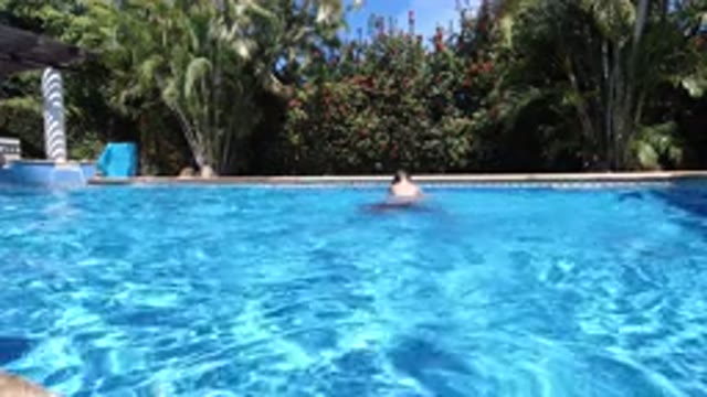 LOS CABOS MEXICO-2020: Man Playing With His Son In The Pool On A Sunny Day