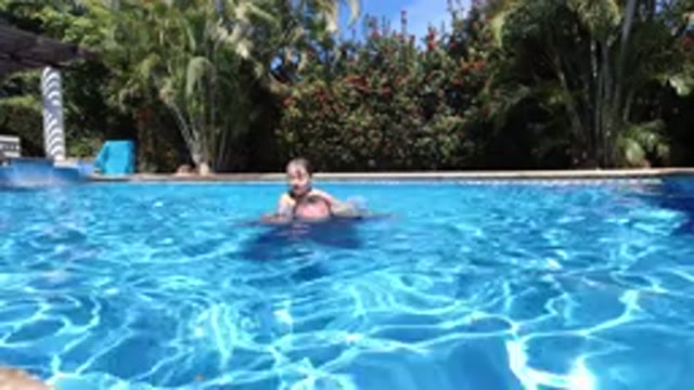LOS CABOS MEXICO-2020: Father And Daughter Playing In A Home Pool On Sunny Day