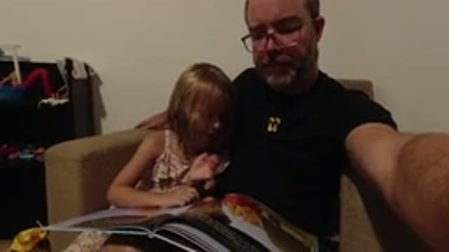 LOS CABOS MEXICO-2020: Father And Daughter Reading A Book While Being Recorded