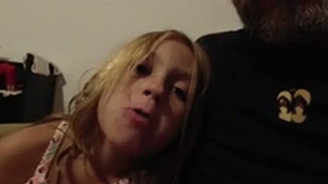 LOS CABOS MEXICO-2020: Blonde Girl Grimacing at Camera While Sitting on Father