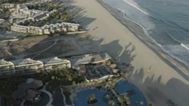 LOS CABOS MEXICO-2020: Drone Flying Over Beach Sunset Waves Ocean Houses People