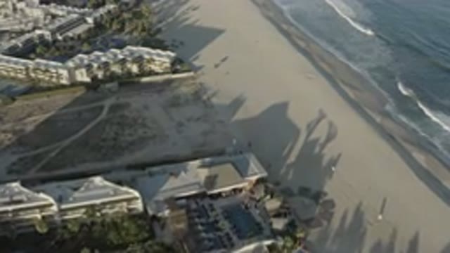 LOS CABOS MEXICO-2020: A Wide Sand Beach With White Bubble Waves And A Large