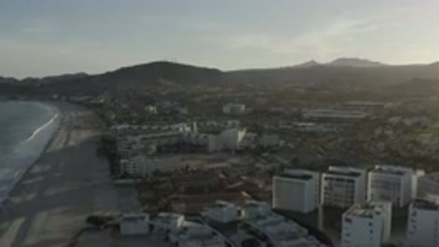 LOS CABOS MEXICO-2020: Overview Of Town By The Sea With Mountains And Buildings