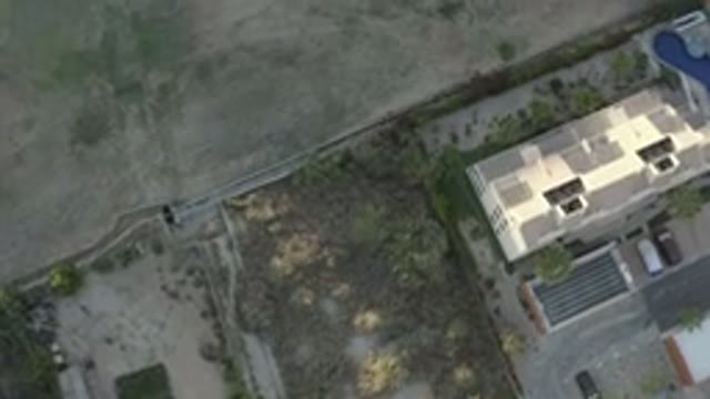 LOS CABOS MEXICO-2020: Aerial Shot Panning Over A Building And A Field In The