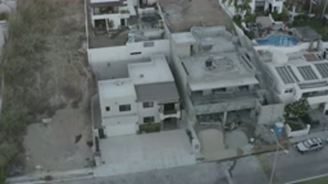 LOS CABOS MEXICO-2020: A View Of Buildings With Trees, A Car And A Pool