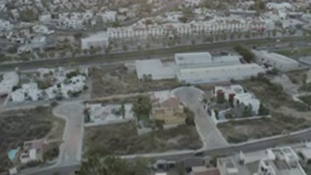 LOS CABOS MEXICO-2020: Aerial View Of Buildings And Freeway With Sand And Palm Trees