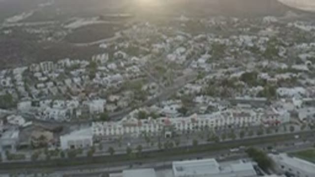 LOS CABOS MEXICO-2020: A View Of A Landmark With Buildings Cars And Road The Sun