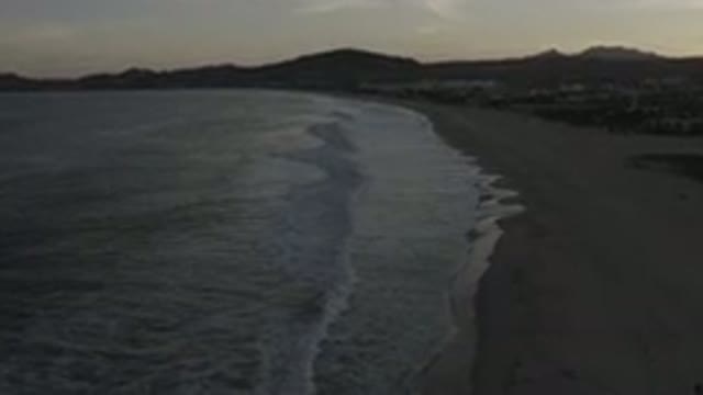 LOS CABOS MEXICO-2020: The Beach At Dusk With Mountains In The Background
