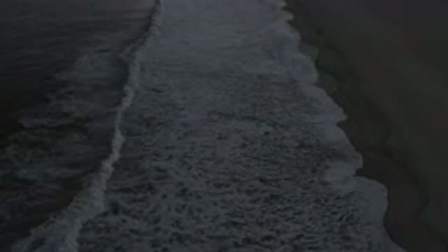 LOS CABOS MEXICO-2020: A Side Top View Of A Wide White Bubbled Wave To The Shore